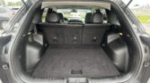 SUV with its hatch open, revealing a spacious black cargo area and upright rear seats in the back row.