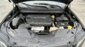 Open hood reveals engine bay of a gray SUV, with a black multi-air 2.4L engine cover in the center and front battery nearby