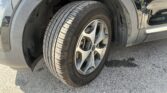 Close-up of a car's front wheel and tire, showing the alloy rim and wheel well.