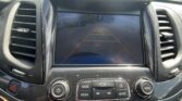 Car rearview camera display with orange parking guide lines on the dashboard screen while parked or backing up.
